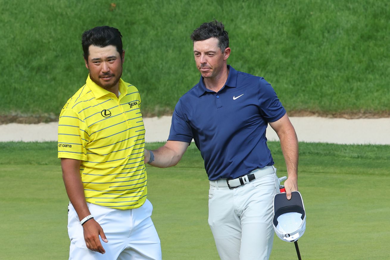 Hideki Matsuyama of Japan and Rory McIlroy of Northern Ireland finish their round on the 18th green during the final round of the Travelers Championship at TPC River Highlands on June 25, 2023 in Cromwell, Connecticut.