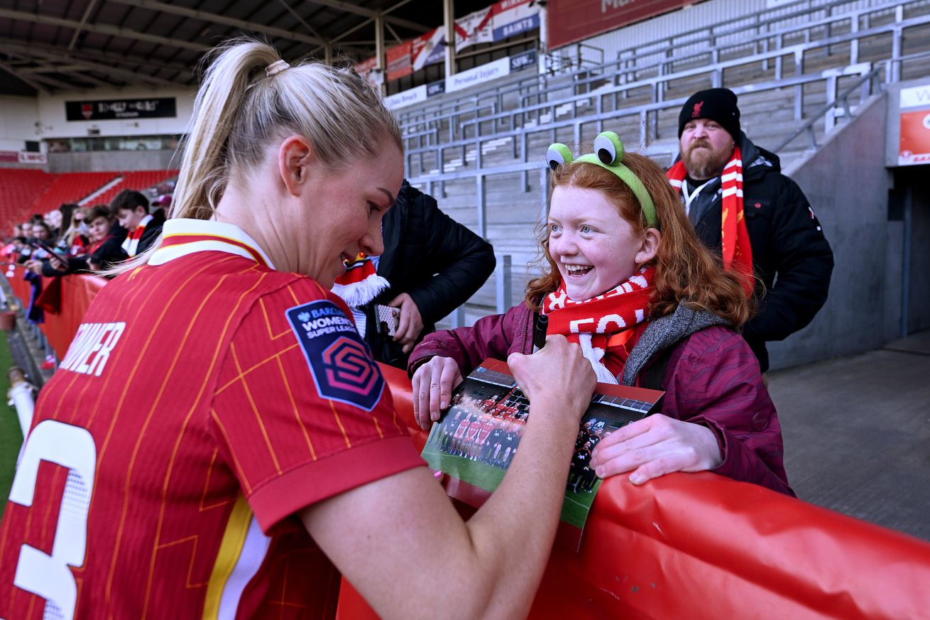 Gemma Bonner of Liverpool Women signing autographs for fans at the end of the Barclays Women’s Super League match between Liverpool FC and Aston Villa FC at The St Helens Stadium on March 30, 2025 in St Helens, England.